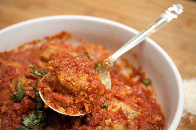 These mouth-watering Mediterranean meatballs, bathed in  double tomato herb sauce, manage to be sumptuous -- airy and fluffy -- yet surprisingly light on calories
