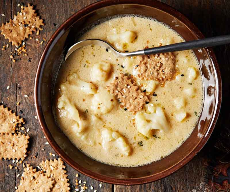 Inspired by Welsh rarebit, a cheesy cauliflower soup dishes up comfort for a crowd
	
	