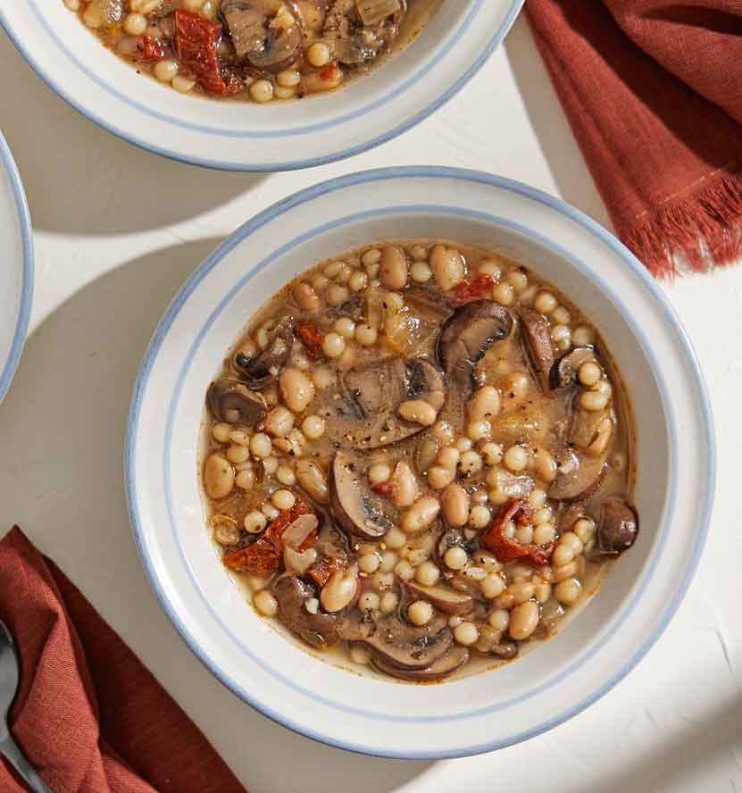 Aromatics and fresh herbs lend to the amazing smell and taste of this hearty, easy Mushroom, Bean and Couscous Soup
	
	