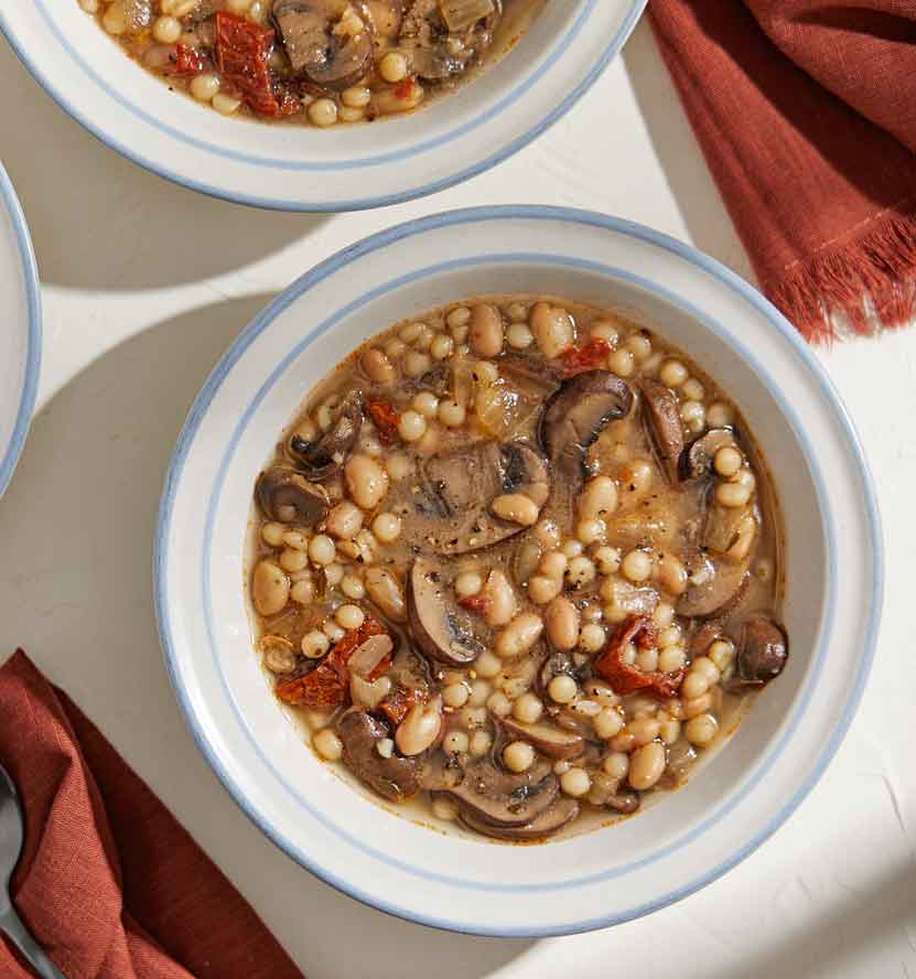 Aromatics and fresh herbs lend to the amazing smell and taste of this hearty, easy Mushroom, Bean and Couscous Soup