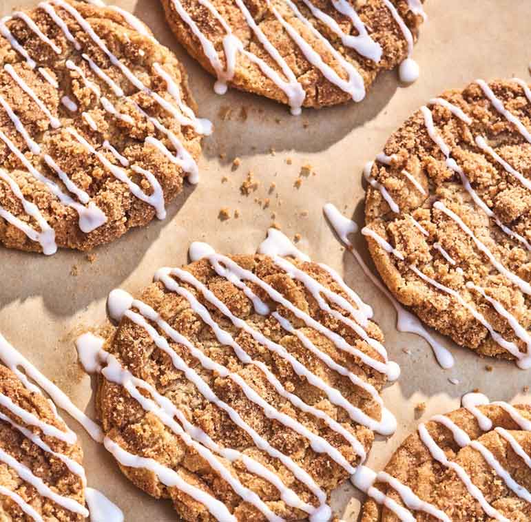 These crisp and chewy coffee cake cookies are packed with brown sugar and cinnamon, coated in buttery streusel, and finished with a drizzle of sweet icing