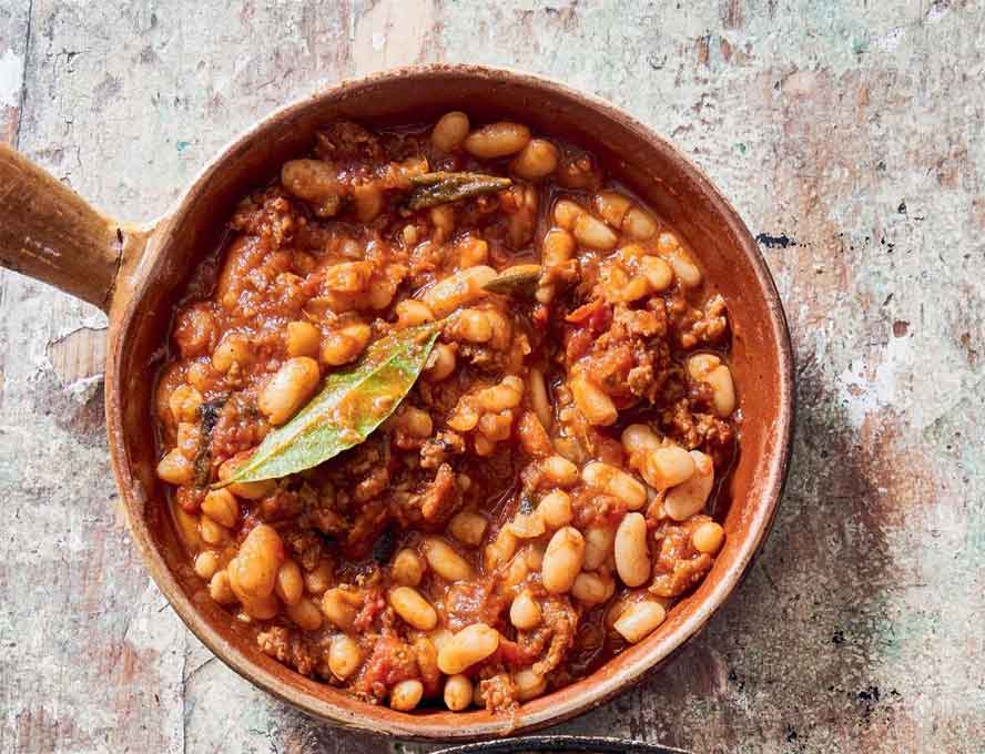 Fagioli all'Uccelletto -- creamy white beans with sausage in a thick and glossy sauce -- is a delectable Italian dish that  makes a hearty one-pan meal

