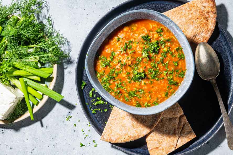Hearty tomato-lentil soup is warm, tangy and filled with Persian flavors
	